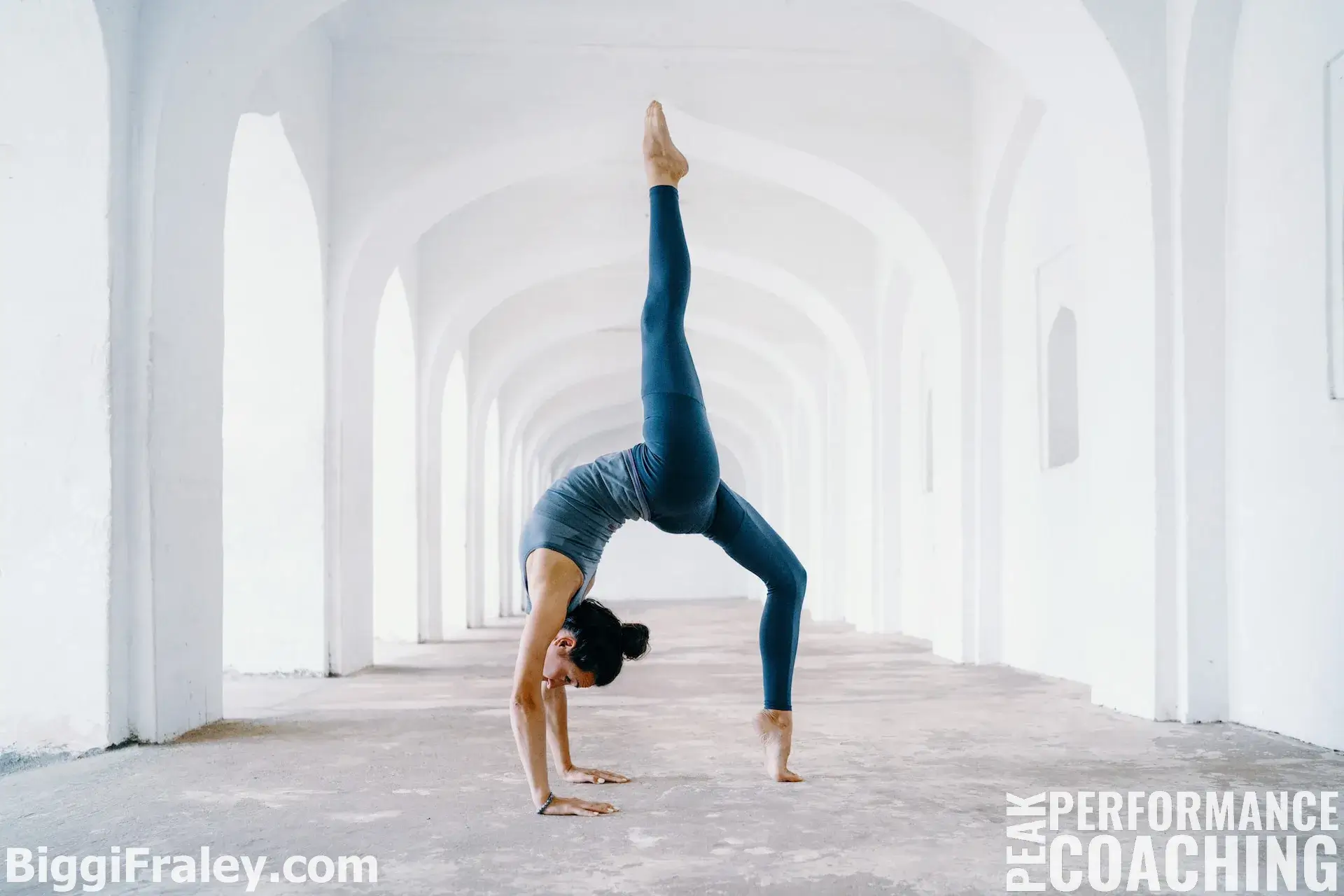 woman doing yoga pose in white archway